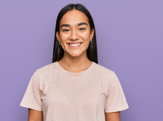 Young asian woman wearing casual clothes with a happy and cool smile on face. lucky person.