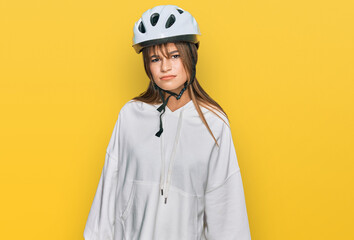 Teenager caucasian girl wearing bike helmet skeptic and nervous, frowning upset because of problem. negative person.
