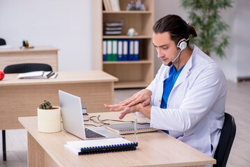 Young male doctor in telemedicine concept