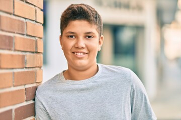 Adorable latin boy smiling happy standing at the city.