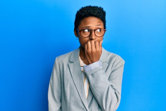 Young african american girl wearing business jacket and glasses looking stressed and nervous with hands on mouth biting nails. anxiety problem.