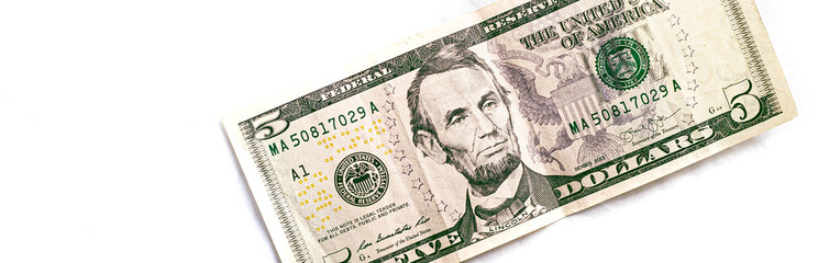 Dollar ( USD ). Money of United States of America. Five dollar bill in close-up with white...