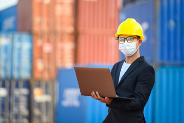 Young Asian male engineer or manager Use of radio communication and laptop computers to control...
