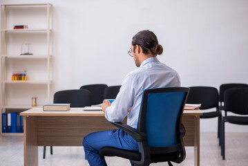 Young male boss giving seminar in the office during pandemic