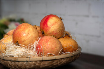 Pomegranate fruit put in bamboo handmade basket for gift and healthy.