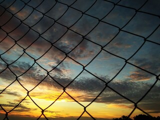 sunset over fence