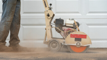 cutting an asphalt driveway with saw