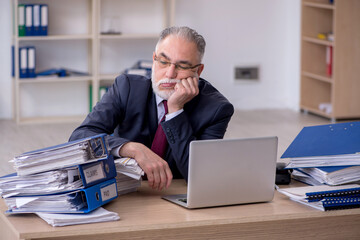 Aged male employee unhappy with excessive work