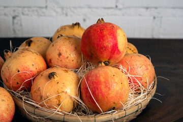 Pomegranate fruit put in bamboo handmade basket for gift and healthy.