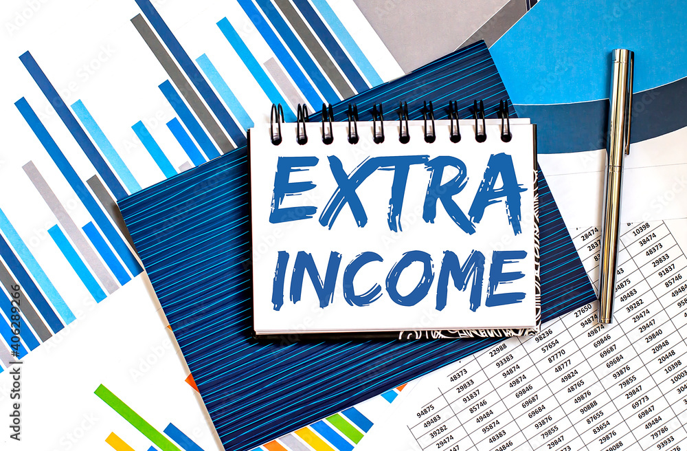 Poster extra income concepts on the notepad with pen and charts