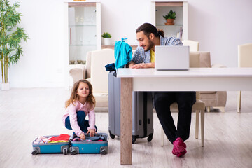 Young man and his small daughter preparing for the trip