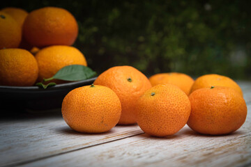 Fototapeta na wymiar Orange put on white wooden nature background for gift and good healthy.