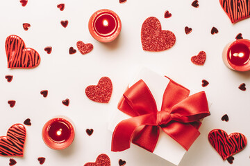 Valentines day minimal: red love hearts, romantic gift box, candle on white background. Sainte...