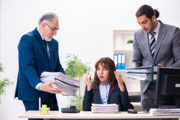 Two male and one female employees working in the office