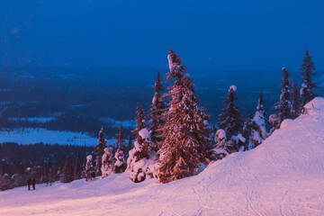 Beautiful night cold scandinavian mountain view of ski resort, sunny winter day with slope, piste...