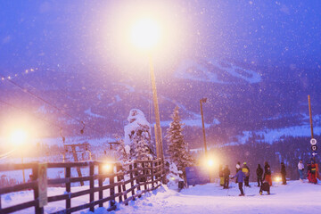 Beautiful night cold scandinavian mountain view of ski resort, sunny winter day with slope, piste and ski lift, scandinavian winter landscape of skiing resort