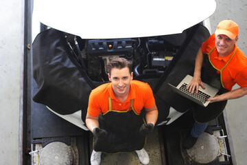 car mechanic use notebook computers to check engine and service maintenance of industrial to engine repair, for transport automobile automotive , top view image