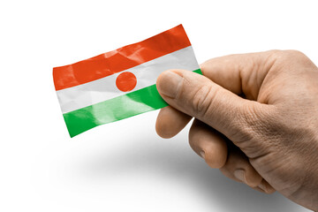 Hand holding a card with a national flag the Niger