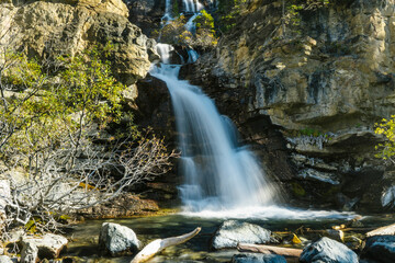 Fototapeta na wymiar Small waterfall with rocks and flora
