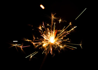 Sparklers burning lights on black background. 