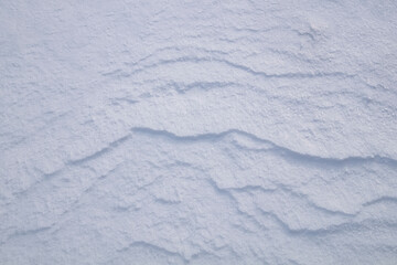Background of fresh snow in blue tones.