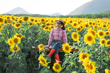 Portrait of female farmer in sunflower field evening time at khao Yai thailand