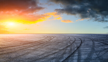 Fototapeta na wymiar Asphalt race track road and sky clouds at sunset.Road ground background.