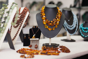 Counter with amber jewelry in store. High quality photo