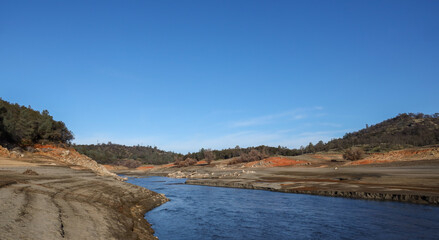 Fototapeta na wymiar Beautiful Red Rock and Shoreline of the North Fork of the American River at Low Water Below the Folsom Reservoir High Water Line