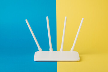 White Wi-Fi router on a yellow and blue background.