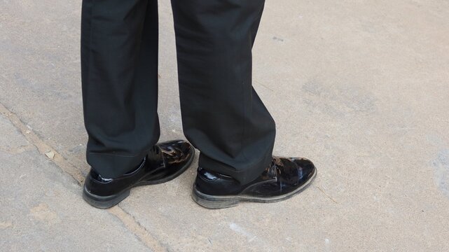 man in black shoes