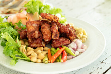 Deep fried pork rib bone on white dish