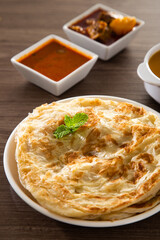 Roti Parata or Roti canai with lamb curry sauce.