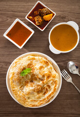 Roti Parata or Roti canai with lamb curry sauce.