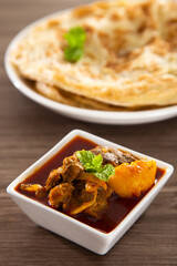 Roti Parata or Roti canai with lamb curry sauce.