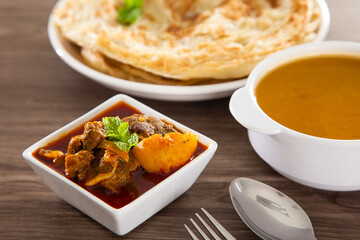 Roti Parata or Roti canai with lamb curry sauce.