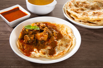 Roti Parata or Roti canai with lamb curry sauce.