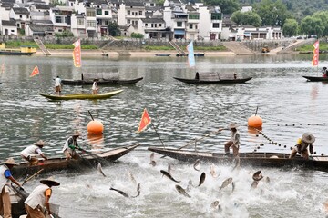 Traditonal fishing in rural China at Yangtze river with two fishermen
