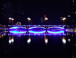 Highleghted bridge with refletion at night in Guilin, China