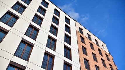 Fragment of modern luxury residential apartment,  home house building concept. Modern apartment building on a sunny day with a blue sky.