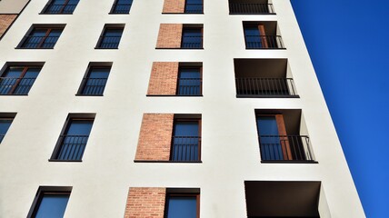Fragment of modern luxury residential apartment,  home house building concept. Modern apartment building on a sunny day with a blue sky.