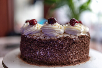 Black forest cherry cake close-up. Sponge cake with chocolate and cherries.