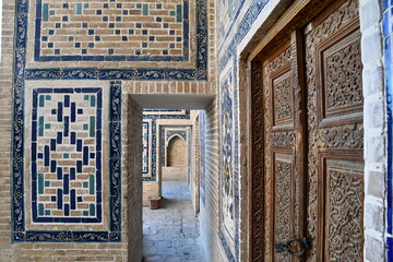 Fototapeta na wymiar A carved wooden door in Samarkand madrasa, Samarkand, Uzbekistan
