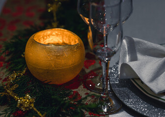 Close-up with the romantic light of the burning candle on a decorative table
