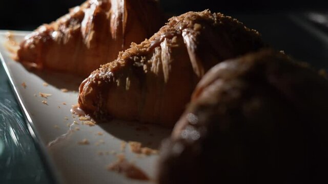 Freshly baked croissants on a baking sheet, showcase in a cafe. tasty breakfast