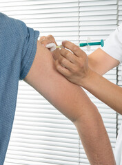woman vaccinated coronavirus, covid-19 and vaccination concept with injection with a syringe at...