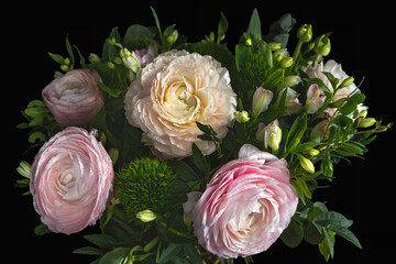 Ranunculus asiaticus and Green Barbatus, a bouquet of flowers on a black background