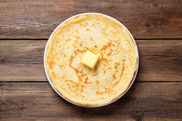Flat lay composition with fresh thin pancakes or crepes on  wooden table . Space for text
