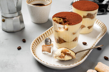 Traditional Italian dessert tiramisu in a glass.