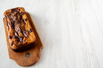 Homemade Chocolate Banana Bread on a rustic wooden board, side view. Copy space.